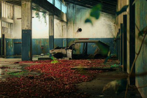 An old burnt car in an abandoned building