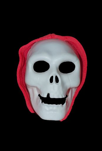 A vertical shot of a halloween skull mask isolated on a black background