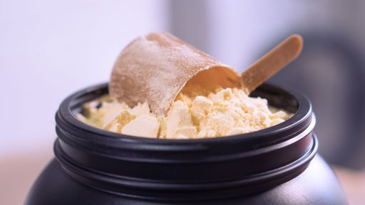 Container of milk whey protein. Close up.