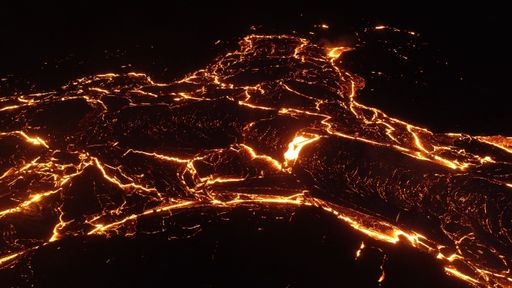 A volcanic eruption with glowing orange lava flow surrounded by a pool of bubbling magma