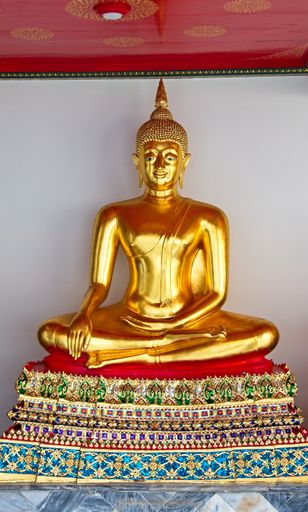 A vertical shot of a golden statue of Buddha captured in Bangkok,Thailand