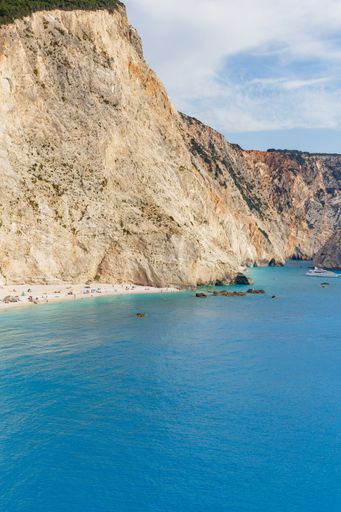 A vertical shot of the tents and the turquoise water of the Porto Katsiki Beach in Lefkada, Greece