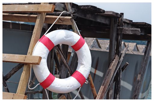 A white and red life buoy. This image can be used to symbolize life saving.