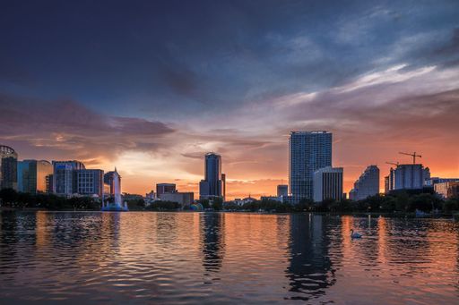 The Orlando Florida Lake Eola cityscape with a sunset on the horizon