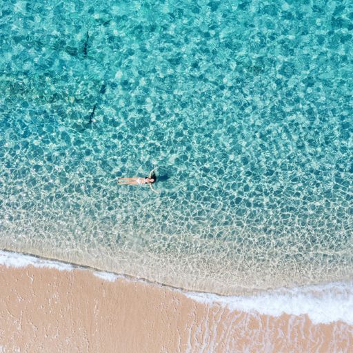An aerial shot of a girl swimming in t