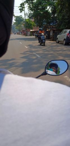 A vertical shot of a biker photographic two other bikers in the front