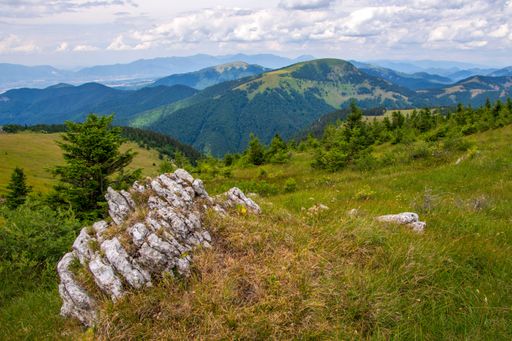 A scenic view of green mountains against the backdrop of a cloudy sky. Big Fatra mountains, Slovakia.