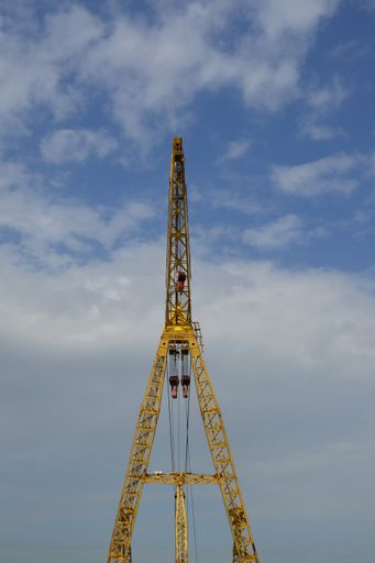 Yellow construction crane with sky background