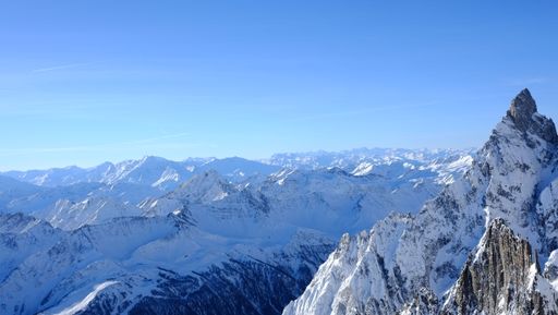 An aerial view of the majestic Monte Bianco mountain range, featuring a stunning winter landscape