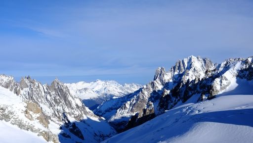 An aerial view of the majestic Monte Bianco mountain range, featuring a stunning winter landscape
