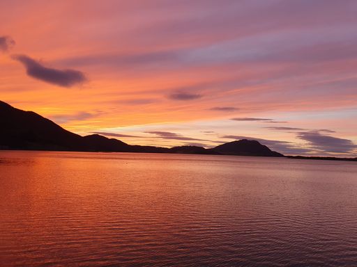The beautiful scenery of a lake at sunset with mountains in the background perfect for wallpapers