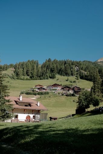 A scenic view of a village in green mountains on a sunny day