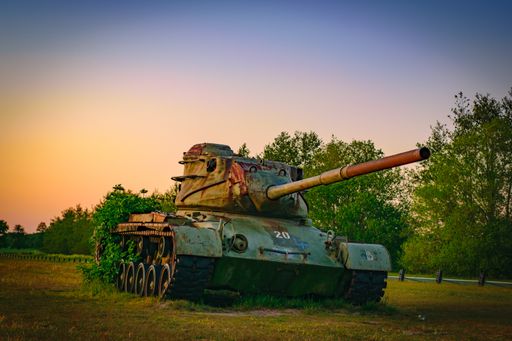 An old tank in the park under the clear sky