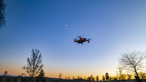 A low angle shot of a drone under the beautiful sunset sky