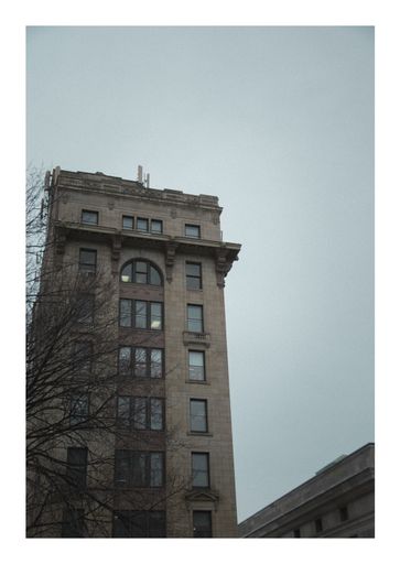 A vertical shot of a stone building on a gloomy day