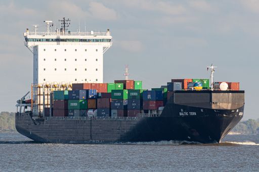 A large cargo vessel with a full load of containers in Port of Hamburg