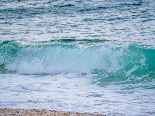 A beautiful shot of waves crashing on the beach with bays and rocks in Croatia