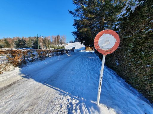 A selective focus shot of an old street stop sign on a snowy winter d