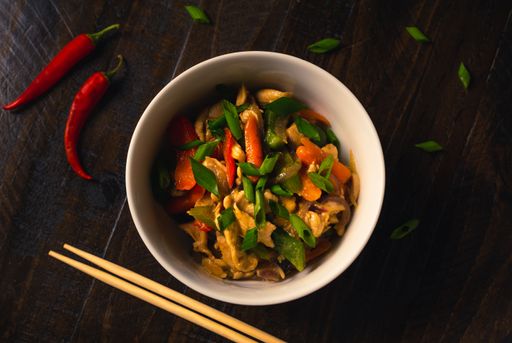 Traditional Chinese chicken stir fry with red onions, peppers, mushrooms, celery and carrot