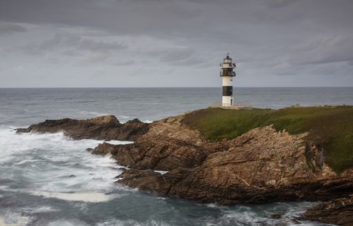 The ocean and Illa Pancha lighthouse in Ribadeo, Galicia, Spa