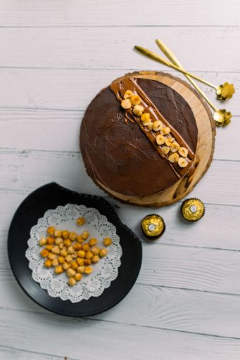 A vertical shot of a delicious chocolate cake on a wooden board