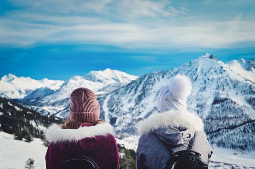 A closeup shot of two people on winter scene background with snowy mountains