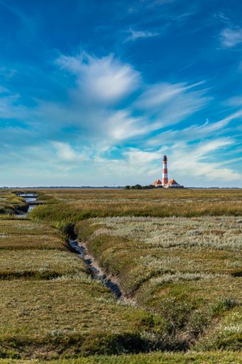 A beautiful landscape view of famous Westerheversand lighthouse in the background, Germany