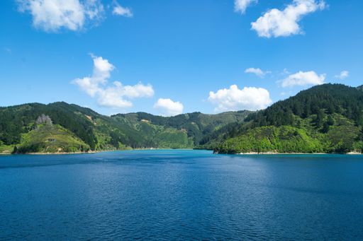 A beautiful view of a pristine lake surrounded by majestic mountain ranges in the South Island of New Zealand