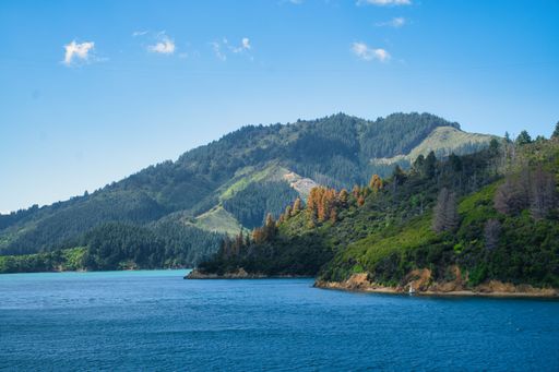 A beautiful view of a pristine lake surrounded by majestic mountain ranges in the South Island of New Zealand