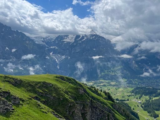 A scenic view of a beautiful mountainous landscape enveloped in clouds in Switzerland