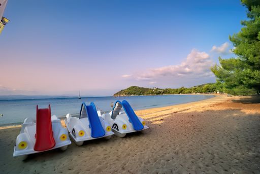 The Aegean sea, water bicycles at the Koukounaries beach in Skiathos island, Greece