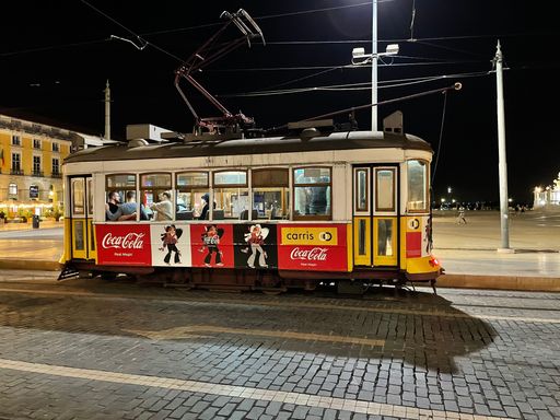The number 28 Estrela tram in Lisbon passing through the city in the evening
