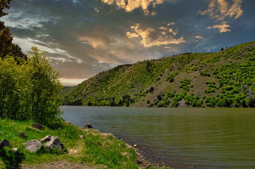 A beautiful shot of sunset over greenery covered hills