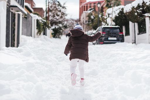 A back view of a child playing in the snow