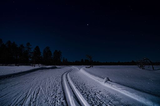 A snowy ski trail at night in Orsa Gronklitt, Sweden