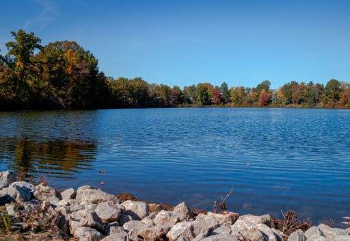 A beautiful shot of the blue  Kenisee Lake with autumn trees on the banks in Jefferson, Ohio