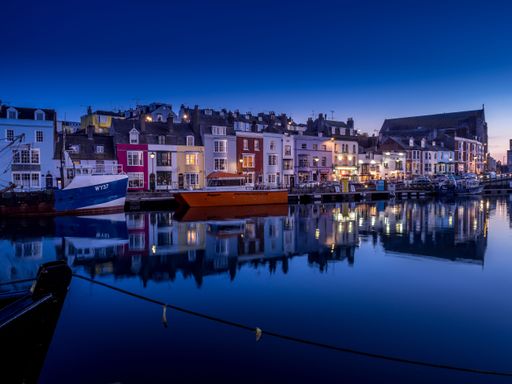 an Aerial shot of the Weymouth harbor at blue hour at night
