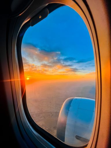 A beautiful sunset scene seen in the clouds from a plane window - the concept of a vacation