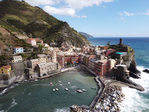 An aerial of a beautiful bay with tall buildings and sailing boats in Portofino, Liguria, Italy
