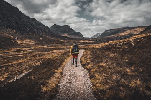 A ba hiker walking on a beautiful mountain pathway