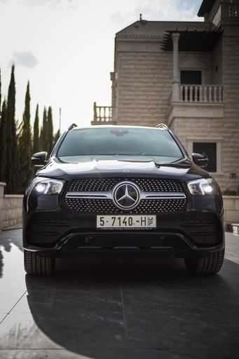 A silver Mercedes Benz AMG 300D 4MATIC parked in a driveway