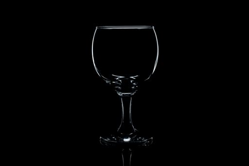 A closeup of a wine glass isolated on a black background