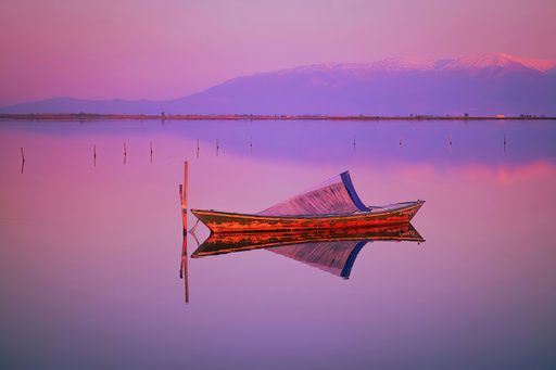 A boat on the lake during the sunset