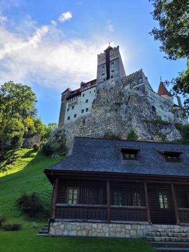 A low-angle view of Bran Castle seen on a beautiful sunny day
