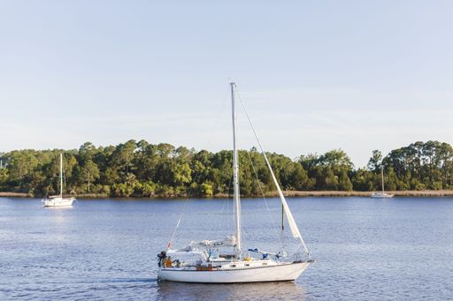 A sailing boat in peaceful blue lake on a sunny day