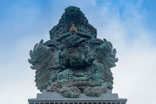 The Garuda Wisnu statue under a blue sky at Garuda Wisnu Kencana Cultural Theme Park in Bali