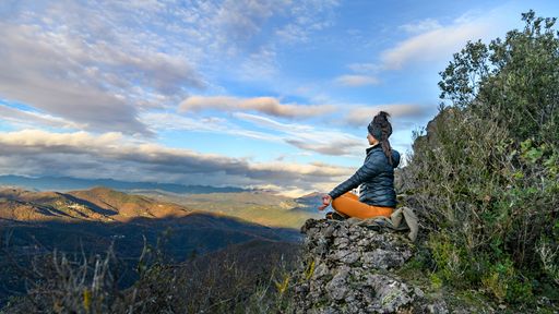 A young female practicing yoga on the side of a mountain in Montpelier, France