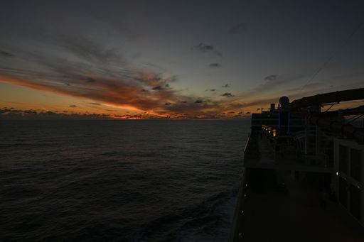 A beautiful shot of the sunset over a seascape at night