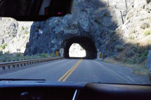The road through the mountain tunnel, view from the car