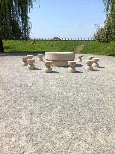 A vertical shot of the Table of Silence under blue sky in a park in Romania